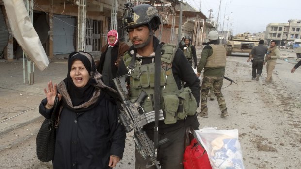 Iraqi security evacuate trapped civilians in Ramadi on Thursday.