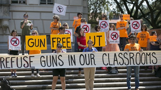 Protesters gather on the West Mall of the University of Texas campus on October 1 to oppose a new state law that expands the rights of concealed handgun licence holders to carry their weapons on public college campuses. 