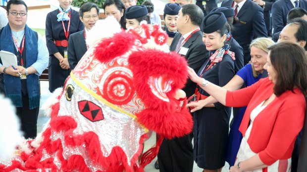 Tourism Minister Kate Jones and Premier Annastacia Palaszczuk watch the Chinese dragons as China Eastern announces first-ever Brisbane to Shanghai flight.