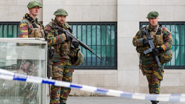 Soldiers stand guard as terror suspect Salah Abdeslam appears in court at a justice building in Brussels in April. 