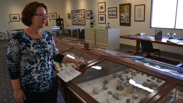 Relief tourism officer Anita Morris examines the display case at Cloncurry Unearthed where 14 minerals were stolen.