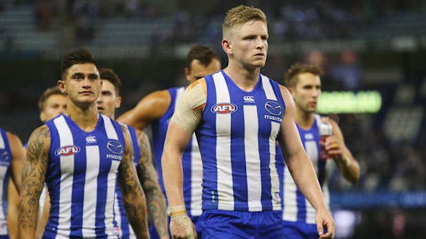 Gut-wrenching: Jack Ziebell leads the Roos off after the disappointing loss.