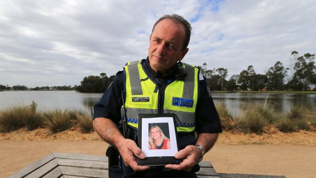 Highway patrol policeman Darryl Crowley holds a picture of his daughter Kelly, who was killed alongside her son in a car crash in March.