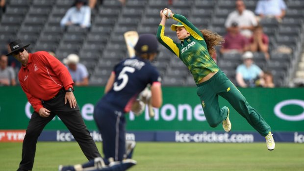 England's Heather Knight is caught by the flying Laura Wolvaartd during the semi-final against South Africa.