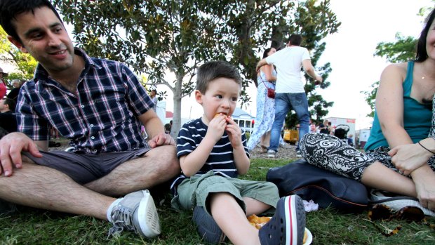 Byron Buick, 2, has his first honey puff with dad Andy Buick at last year's Paniyiri Greek Festival.