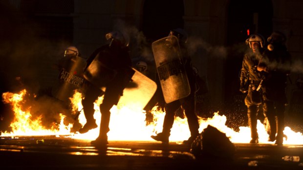 Riot police try to avoid petrol bombs thrown by anti-austerity protesters in Athens on Wednesday.