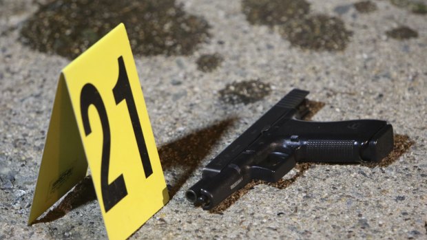 A gun sits by a marker following a shooting on Friday in Philadelphia.
