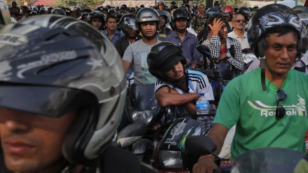 Nepalese motorists wait for their turn to fill their motorbikes at a fuel pump run by the Nepalese army in Kathmandu, Nepal on Monday.