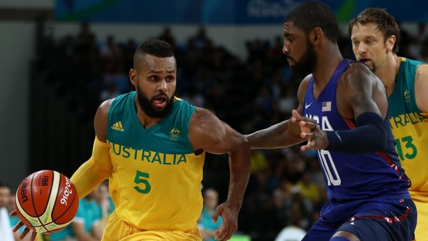 Scoring spree: Boomers guard Patty Mills tries to get past American rival Kyrie Irving.