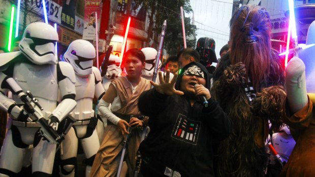 Fans in Taiwan dressed as Star Wars characters parade outside a movie theater showing Star Wars: The Force Awakens.