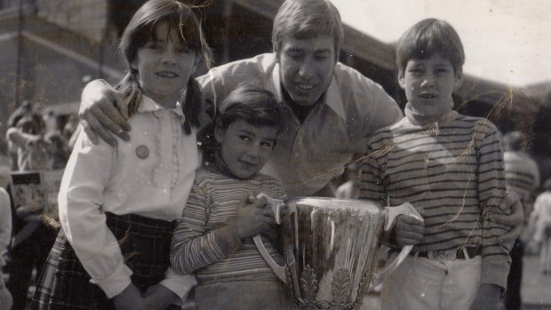 Caroline Wilson with sister Amelia, brother Will, Bill Barrot and the Richmond 1969 premiership cup.