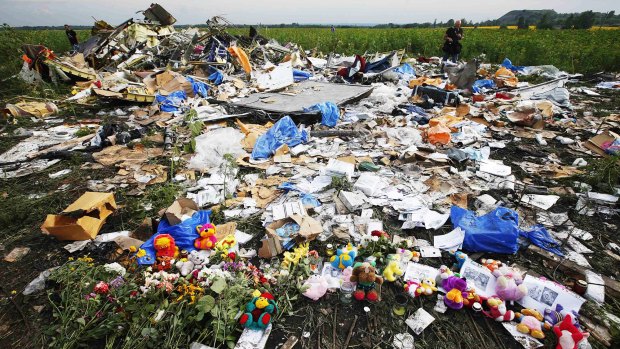 Flowers and mementos placed at the crash site of Malaysia Airlines Flight MH17 near the settlement of Rozspyne in Donetsk.
