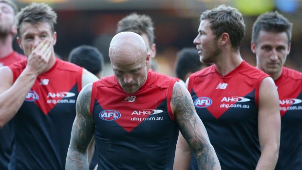 Nathan Jones leads the dejected Demons from the field.