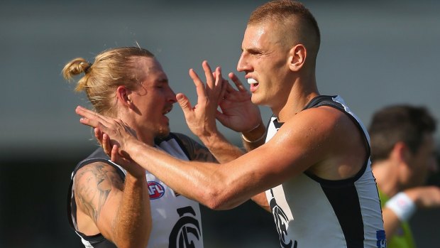 Liam Jones is congratulated by Dennis Armfield after kicking a goal during the Carlton intra-club match on Friday.