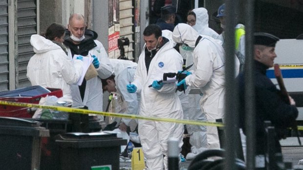 Forensics officers outside 8 Rue du Corbillon in Saint-Denis, Paris, on Wednesday.  The body of Abdelhamid Abaaoud was identified using DNA and fingerprints.