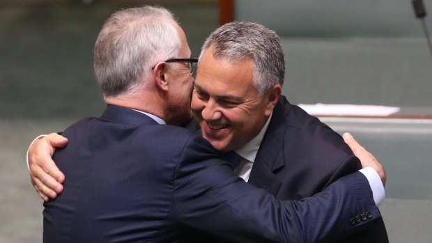 Prime Minister Turnbull embraces Treasurer Joe Hockey after his valedictory speech.
