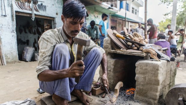 A blacksmith repairs tools at a market in Sambhal. Prime Minister Narendra Modi's Hindu-nationalist Bharatiya Janata Party is seeking to woo Dalits to win the state's legislative elections in 2017.