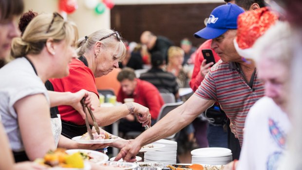 Volunteers serve Christmas lunch for From Us 2, an independent grassroots charity providing meals, clothes and shoulder to cry on to the homeless.