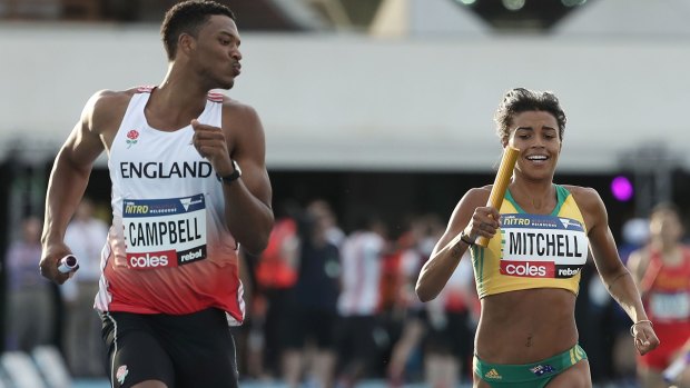 Briton Theo Campbell blowing Australia's Morgan Mitchell a kiss as he passes her to win the mixed 4x400 metre relay at Nitro.