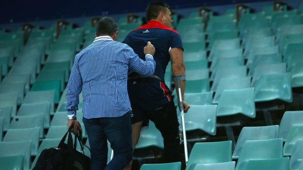 Making the long walk: Jared Waerea-Hargreaves walks up the steps at Allianz Stadium on crutches after his knee injury in round 24.