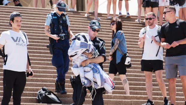 A police officer walks down the Sydney Opera House steps after the protest.