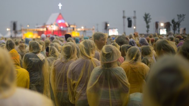 People wear plastic raincoats as they wait for the mass to be held by Pope Francis in Tacloban.