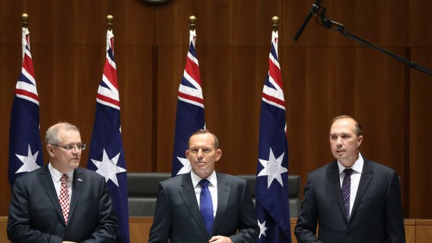 There's a boom: Mr Morrison, Mr Abbott and Mr Dutton wait for a roundtable meeting. 