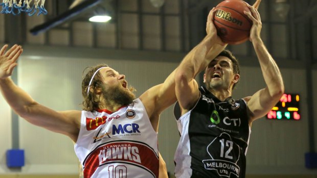 On guard: Todd Blanchfield goes to the basket against Illawarra’s Larry Davidson. 