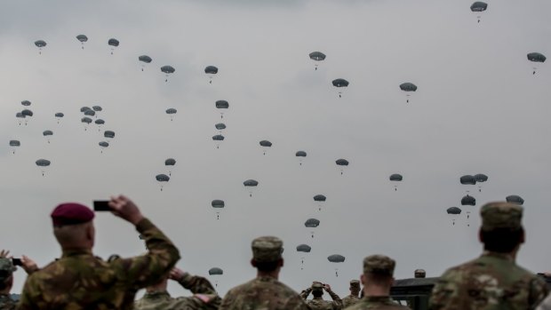Soldiers watch on US, UK and Italian paratroopers take part in a training exercise in Germany.