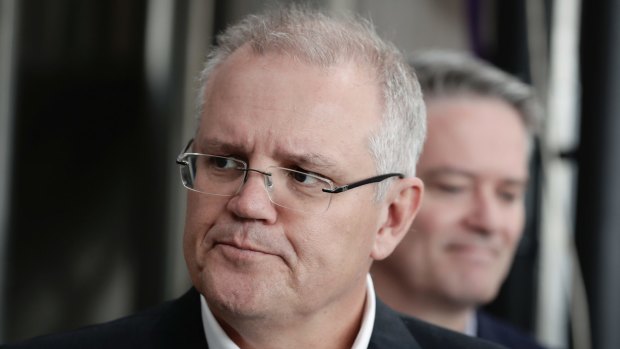 Treasurer Scott Morrison and Minister for Finance Mathias Cormann address the media during their visit to the Capital Brewing Company in Canberra on Friday.