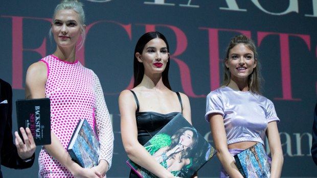 American models Karlie Kloss, Martha Hunt, and Lily Aldridge attend a press conference before the event. 