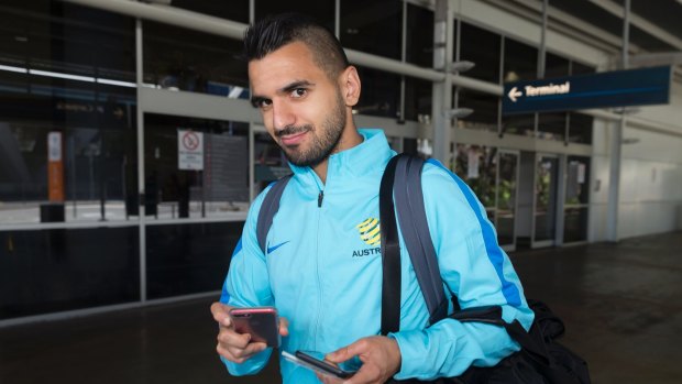 Rested and relaxed: Aziz Behich as the Socceroos arrive back in Sydney on Sunday.