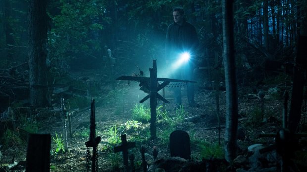 Clarke, as Louis, investigates the burial ground in Pet Sematary. 