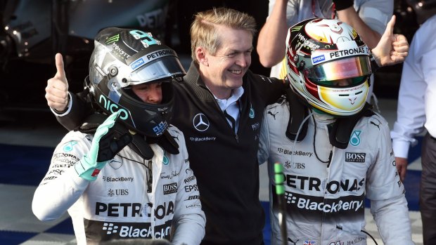 British driver Lewis Hamilton (right) celebrates with teammate Nico Rosberg (left) and Thomas Weber (centre) of Mercedes.