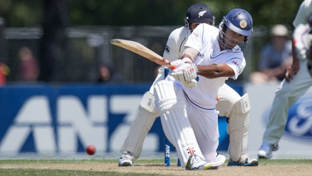 Sri Lankan opener Dimuth Karunaratne sweeps during his knock of 152 on the third day of the first Test against New Zealand.