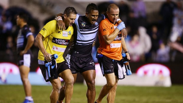 Painful exit: Sharks five-eighth Ben Barba is assisted from the field.