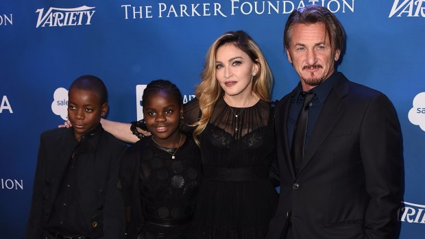 Madonna with son David Banda and daughter Mercy James and Sean Penn at a Haiti gala last year. 