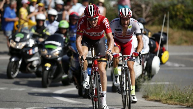 Despite suffering a dislocated shoulder on stage two, Australian Lotto-Soudal rider Adam Hansen, left, is set to continue his record unbeaten run of 12 grand tour finishes.