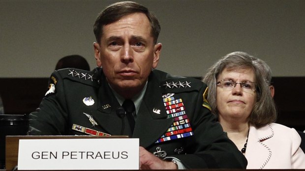 David Petraeus with his wife Holly seated behind him, back in 2010.