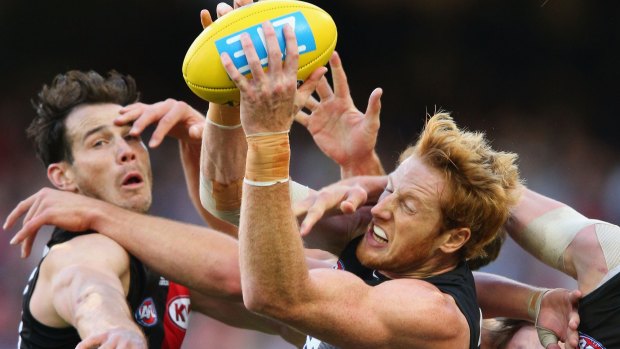 Carlton's Andrew Phillips marks as Matt Dea of the Bombers tries to block.