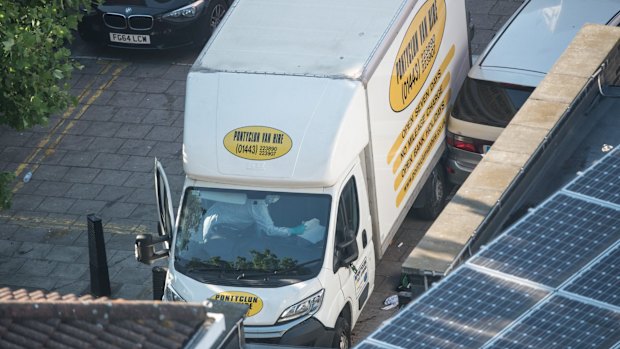 Police inspect a hired van near Seven Sisters Road, where one man died in what police are treating as a terrorist attack.