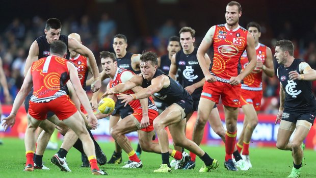 The Blues' Patrick Cripps stretches for the ball in a pack at Metricon Stadium.