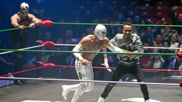 Lewis Hamilton pretends to fight with famous Mexican Lucha Libre wrestler Mistico during a promotional event in Mexico City on Wednesday.