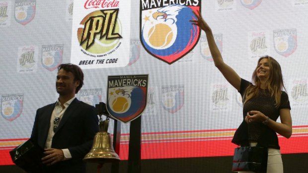Daniela Hantuchova of Slovakia throws a tennis ball to stock traders as Carlos Moya of Spain looks on at the inaugural listing of the IPTL at the Philippine Stock Exchange in Makati city, east of Manila, on Friday.