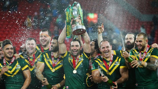 On top of the world again: Cameron Smith lifts the trophy with teammates after victory in the Four Nations final.