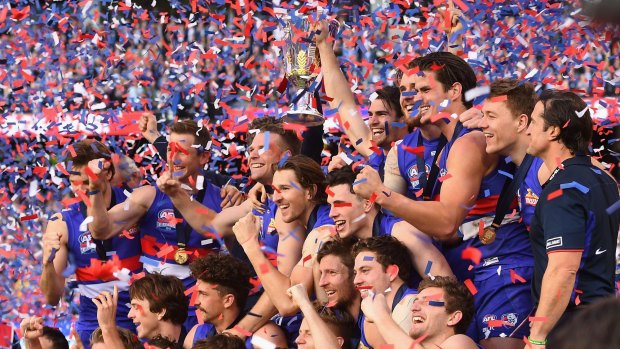 The Western Bulldogs pose with the Premiership Cup after winning the 2016 AFL grand final over the Sydney Swans.