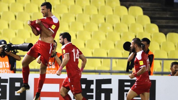 Syria's Omar Al Soma celebrates after scoring in the first leg against Australia.