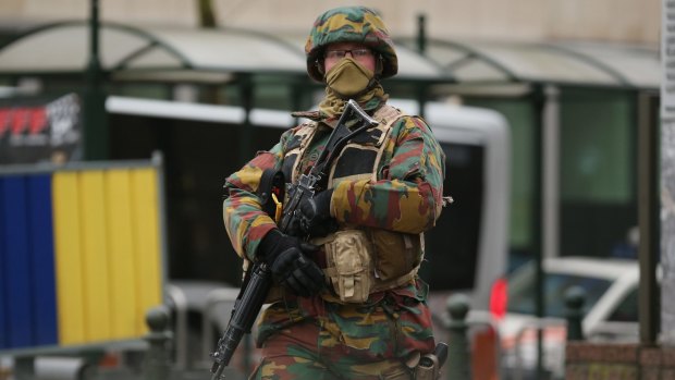 An armed soldier patrols near the EU Commission headquarters after this week's terrorist attacks.