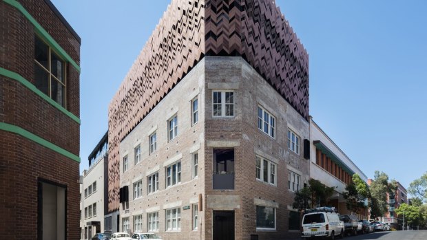 The beautifully restored building stands out with herringbone screens, for balcony privacy.