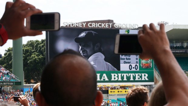 Salute: Fans record the big screen tribute to Hughes.